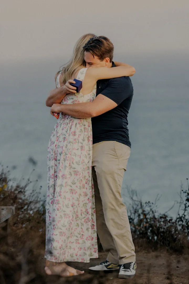 Kayley and Jack holding each other by the sea