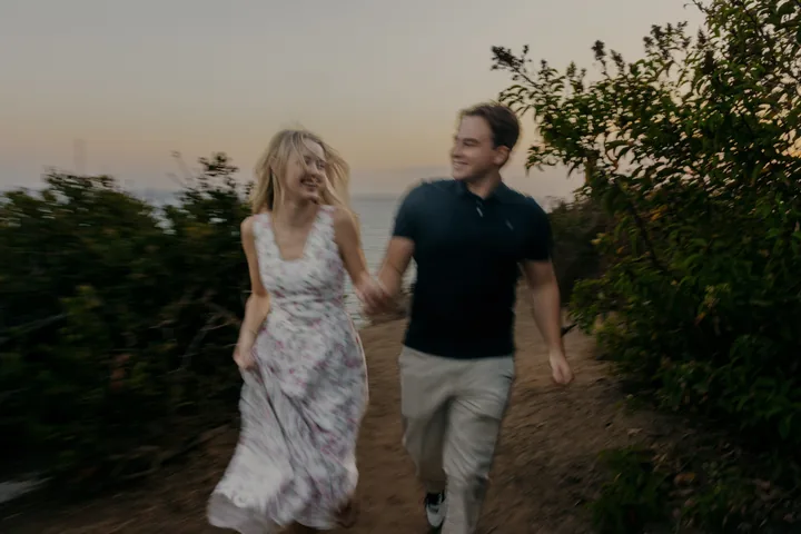 Kayley and Jack laughing as they walk together, captured in motion