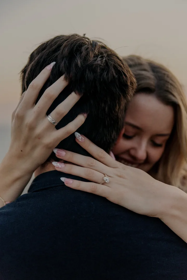 Kayley embracing Jack, with her engagement ring visible over his shoulder