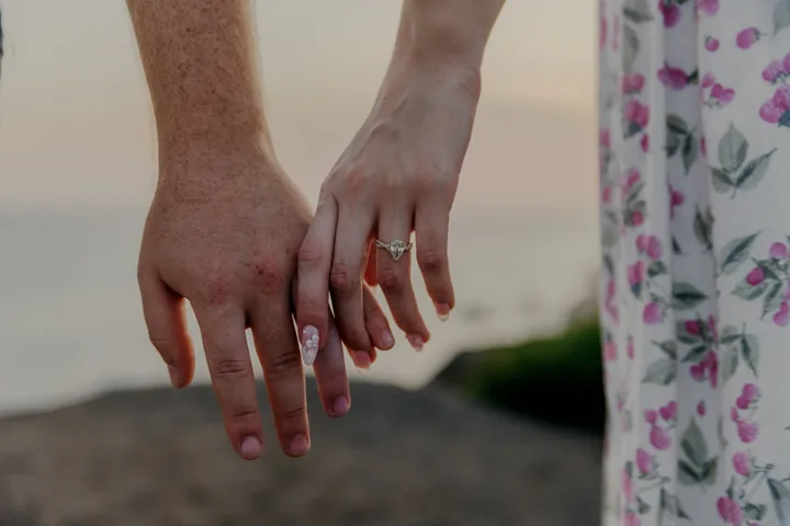 Kayley and Jack's hands together, with her engagement ring visible