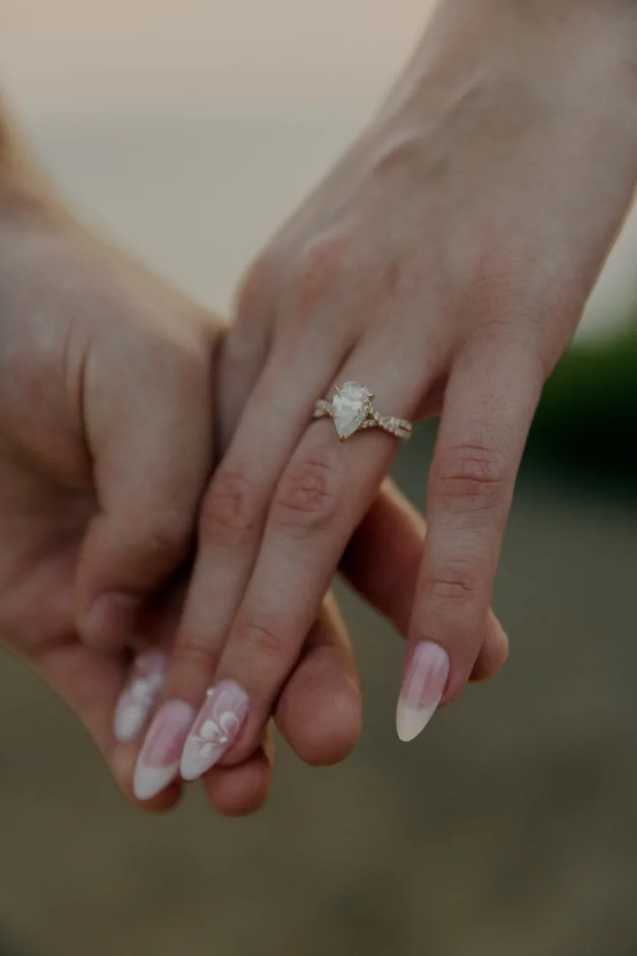 Close-up of Kayley's engagement ring as Jack holds her hand