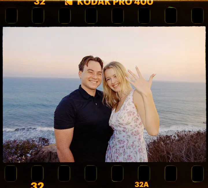 Film-framed portrait of Kayley showing her ring beside Jack